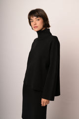 Maglia nera a collo alto con maniche ampie