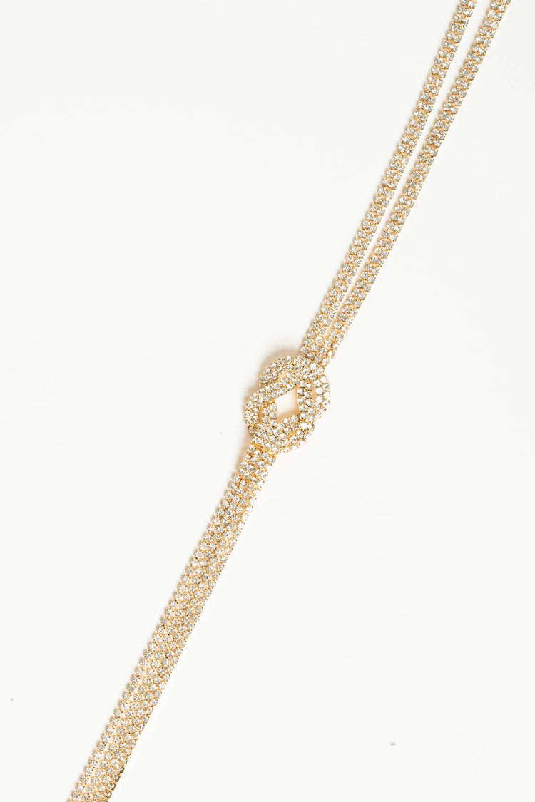 Collana lunga oro con nodo geometrico e strass